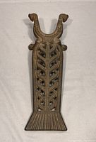Top view showing the ornate leaf patterned openwork and U-shaped forked holder ends with decorative tips on the antique cast iron boot jack.