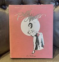 Front cover of the book showing title, author, and burlesque dancer illustration with minor edge wear.