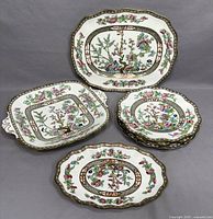 Full set showing four plates stacked, small oval dish, a handled square tray, and a larger oval platter all decorated in Indian Tree pattern.