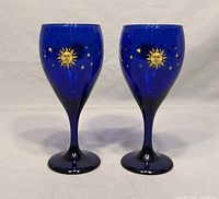 Pair of cobalt blue wine glasses showing front sun and star pattern