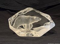 Front view of the clear glass polar bear paperweight sculpture showing the bear figure inside and the ice block shape