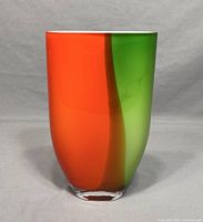 Front view of two-tone orange and green glass vase showing color division and rounded shape