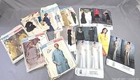 Lot of vintage Vogue Paris Original and Vogue Couturier Design sewing patterns laid out on flat surface.