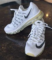 White women’s Nike Air Max 2016 sneakers with black swoosh, size 8, front-left angle showing laces, tongue, sole