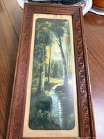 Full view of framed vintage painting showing the night forest and stream scene with harvest moon.