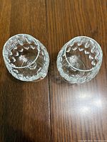 Top down view of two clear crystal brandy snifters showing the detailed faceted cut glass pattern inside the bowl.