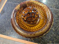 Top view of the amber-toned Cloud Glass floral display bowl showing the flower frog at the center with multiple holes.