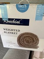 Boxed photo showing Fawcett Kouchini weighted blanket, 15 lb, charcoal color, 47x72 inch size