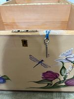 Photo of the interior highlighting the wooden inside and the key attached to the lock.