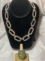 Silver RLL chain necklace displayed on black stand. The chain consists of rectangular links.