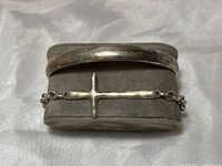 Front view of both bracelets showing the cuff and cross chain