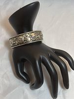 Sterling silver 925 bracelet with raised 3D turtle motifs displayed on a hand mannequin.