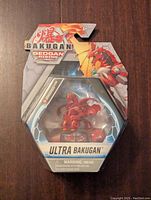Front view of Ultra Bakugan Geogan Rising Dragonoid figure in unopened packaging showing character and brand details.