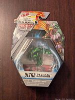 Front of unopened hexagonal Bakugan Ultra Bakugan Falcron packaging with the toy visible inside and character artwork on top right.
