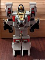 Front view of the Bandai White Tigerzord 1994 toy standing, showing its head, chest, arms, and legs with detailed color accents.