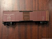 Side view of brown Canadian Pacific model train boxcar 240146 showing text and detailing.
