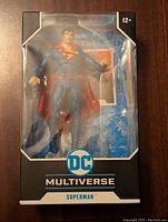 Front view of Superman figure in boxed packaging, showing figure and branding.