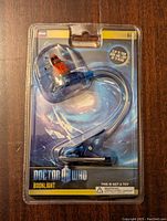Front view of unopened Doctor Who booklight packaging showing Dalek design and flexible neck with clip base.