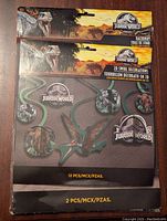 Photo showing the Jurassic World backdrop with dinosaur scene packaging.