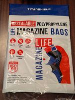 Front of packaging showing TitanShield brand, resealable polypropylene magazine bags, acid-free, archival safe, 150 micron thickness, prevents bent corners.