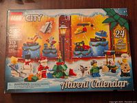 Front view of the boxed Lego City Advent Calendar 60201 showing the main box art with minifigures and builds on a festive snowy background