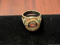 Front view of the Montreal Canadiens 1930 Stanley Cup ring showing team logo and decorative stones.