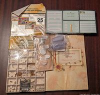 Lot of office and crafting items arranged on a table, shows sticky note set, stamp protectors, wooden shapes, and stationery set