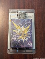 Front view of sealed Pokemon Storm Rider Zapdos Theme Deck showing Zapdos card back artwork through clear blister packaging.