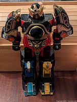 Front view of Power Rangers Thunder Megazord assembled figure standing upright on wood surface.