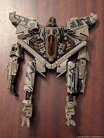 Robot mode of Starscream action figure, showing detailed robotic parts, wings, and cockpit area.