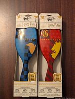 Front view of two original boxed Wet Brush hair brushes featuring Harry Potter Ravenclaw and Gryffindor house designs in blue and red respectively.