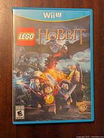 Front cover of Wii U LEGO The Hobbit game case showing character artwork and branding.