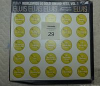 Image of front cover of Elvis Worldwide 50 Gold Award Hits Volume 1 showing song titles and design