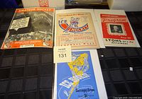 Lot display showing four different vintage hockey programs from 1947-1957 with various cover designs including black and white and color prints.