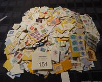 Top view of pile of mixed postage stamps mostly from Canada with some USA and UK