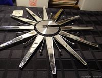 Front view of the starburst clock showing reflective rays and central face