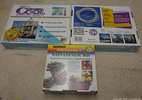 Photo of two Arizona Crystal Cool Outdoor Mist Cooling Kits and one Raindrip Drip Watering Container Kit in their original boxes, showing product branding and features.