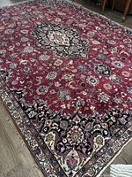 Overall view showing rectangular red field with central medallion and surrounding floral motifs.