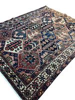 Full view of rug showing overall pattern and colors on wood floor