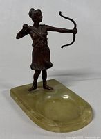 Angle showing front view of bronze sculpture of Artemis Diana on onyx base with ring dish area.