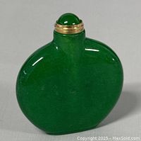 Front and back views of the polished spinach green jadeite bottle with screw-on gold-tone lid topped by a jadeite cabochon.
