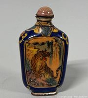 Front view showing hand painted tiger with detailed brushwork on a copper bottle with blue and yellow highlights.