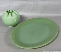 Shows both the small vase and the platter side by side on a neutral background highlighting size and color.