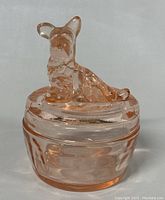 Front view of the pink Jeanette glass dish with Scottish Terrier lid showing overall shape and color.