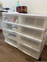 Two stacked GSC plastic storage drawer cabinets on casters showing front and side with transparent drawers.