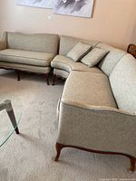 Overall view of the three-piece sectional sofa showing curved corner section and right end section