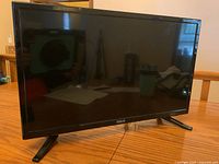 Front of RCA 24 inch flat panel TV showing screen and front bezel with RCA logo.