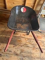 Front view of metal body showing interior with rust and wear, sticker visible inside tub.