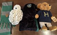 Full view of all four items in the lot: scarf, owl plush, robe, and bear plush