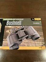 Box with image and branding of Bushnell Falcon PowerView 7x35 binoculars showing product image and magnification details.